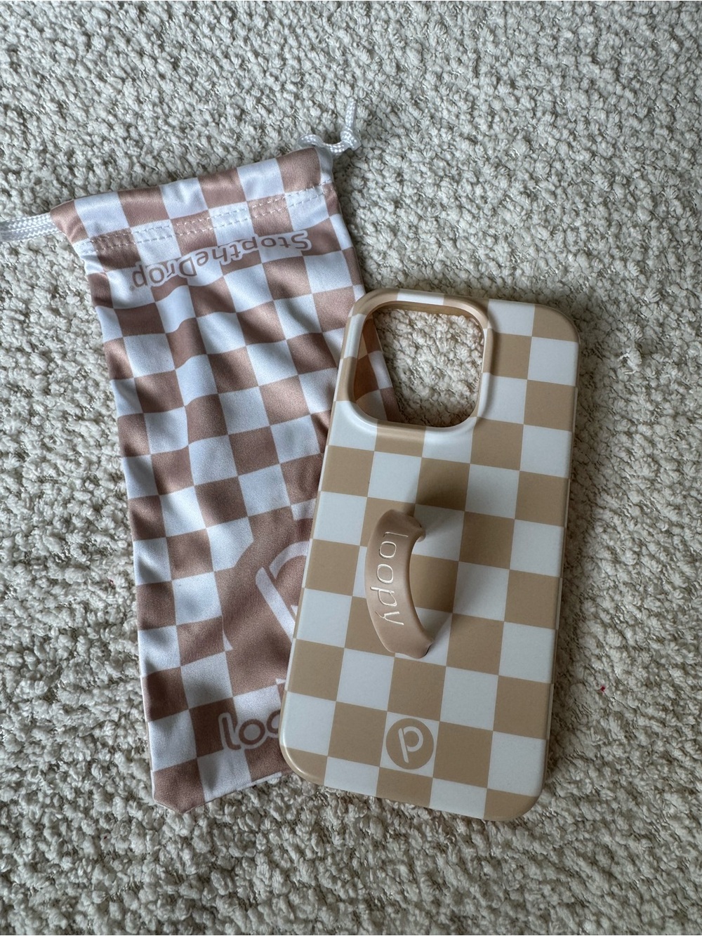 Loopy case for iPhone 15 pro. Tan and white checkered with tan loop